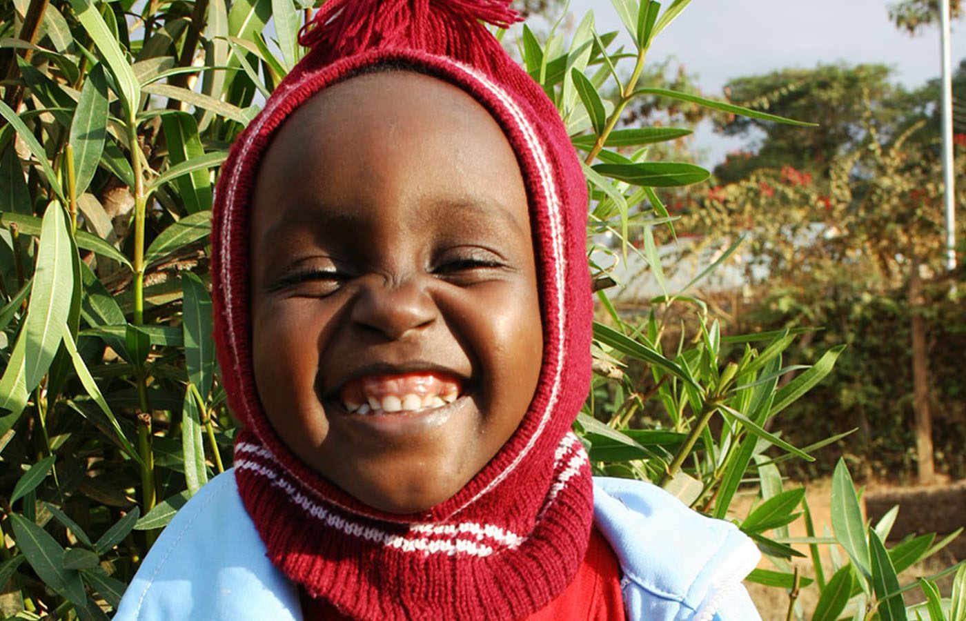 young girl in kenya wearing a knitted hat